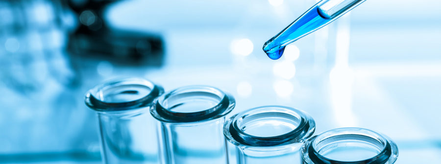 pipette and test tube on blue background